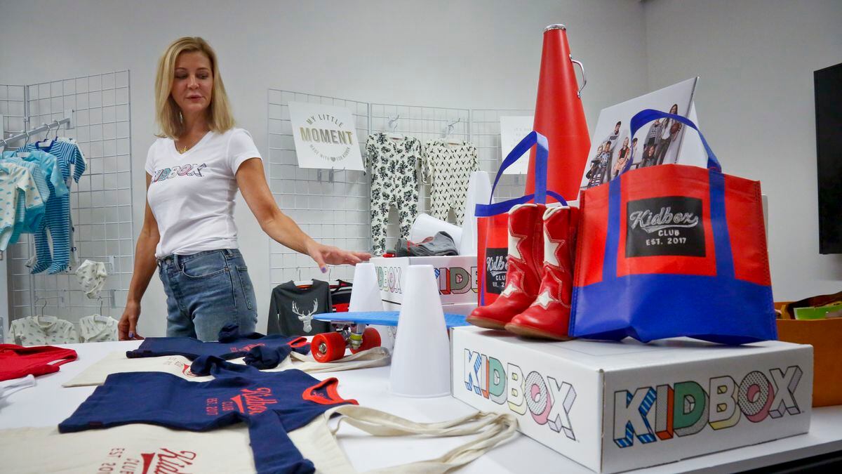 FILE - In this June 25, 2018, file photo, Kidbox CEO Miki Racine Berardelli, shows products for her online styling service for kids, in New York. Walmart is teaming up with Kidbox, the 3-year-old online styling service for children, to offer its customers an exclusive, curated style box. Starting Tuesday, April 16, 2019, Walmart customers will get access to more than 120 premium children’s brands. (AP Photo/Bebeto Matthews, File)