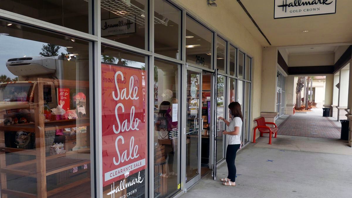A sale sign is displayed near the entrance of a Hallmark store Tuesday, Jan. 12, 2021, in...
