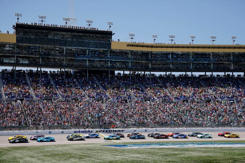 Drivers head down the front straightaway at the start of a NASCAR Cup Series auto race at...