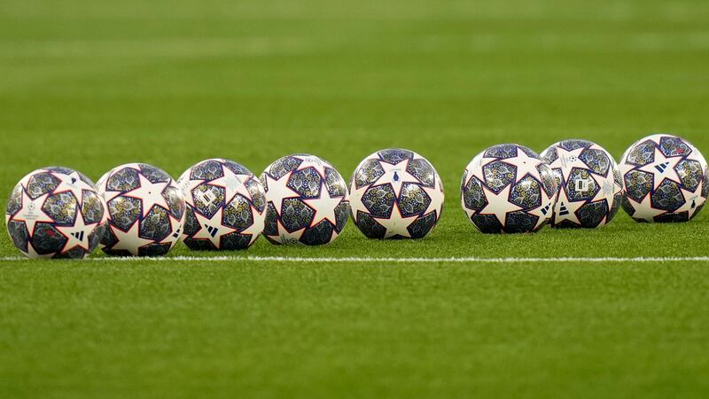 Soccer balls sit on the pitch ahead of the Champions League final soccer match between...