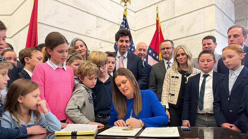 FILE - Arkansas Gov. Sarah Huckabee Sanders signs an education overhaul bill into law, March...